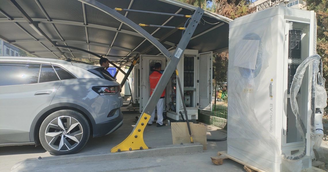Commercial EV charging station installation with technicians and electric vehicles.