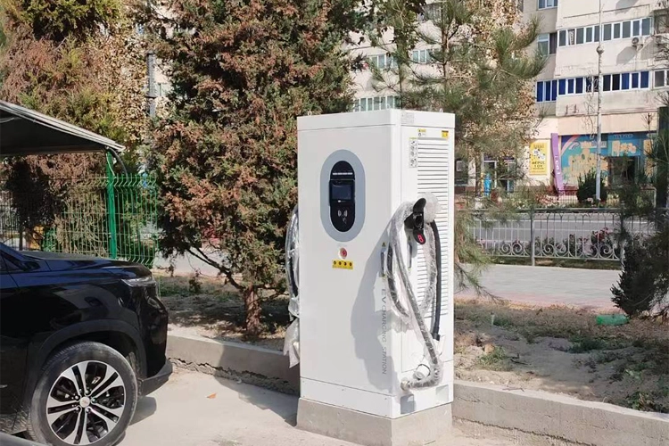 Commercial EV charging station beside parking area, electric car charger for business use in modern city.
