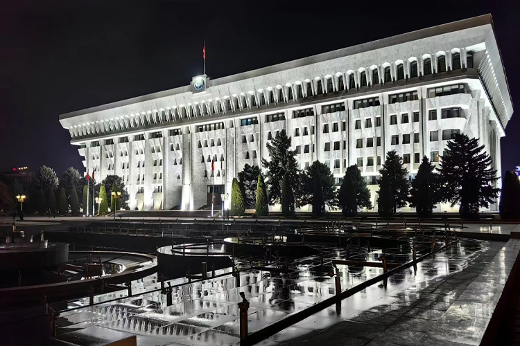 Government building in Bishkek, Kyrgyzstan, illuminated at night, symbolizing the country's growing EV charging infrastructure and clean energy development.