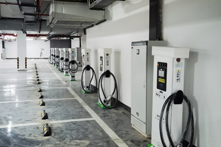 EV charging stations for hotels installed in an indoor parking garage, featuring multiple DC fast chargers arranged in a row for commercial EV charging.
