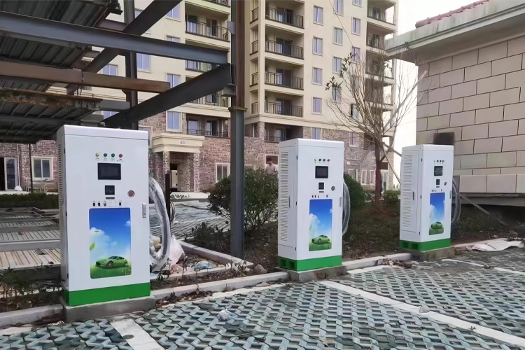 Outdoor hotel EV charging stations with multiple DC fast chargers installed in a residential-style parking area.