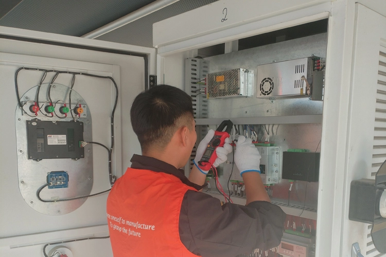 Technician performing maintenance on a level 3 DC fast EV charger at a commercial charging station.