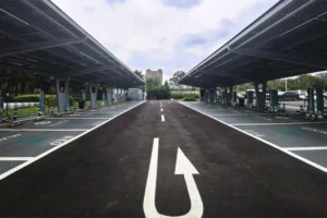 Solar-powered EV charging carport with multiple covered parking spaces and fast charging stations.